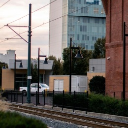a train track next to a brick building