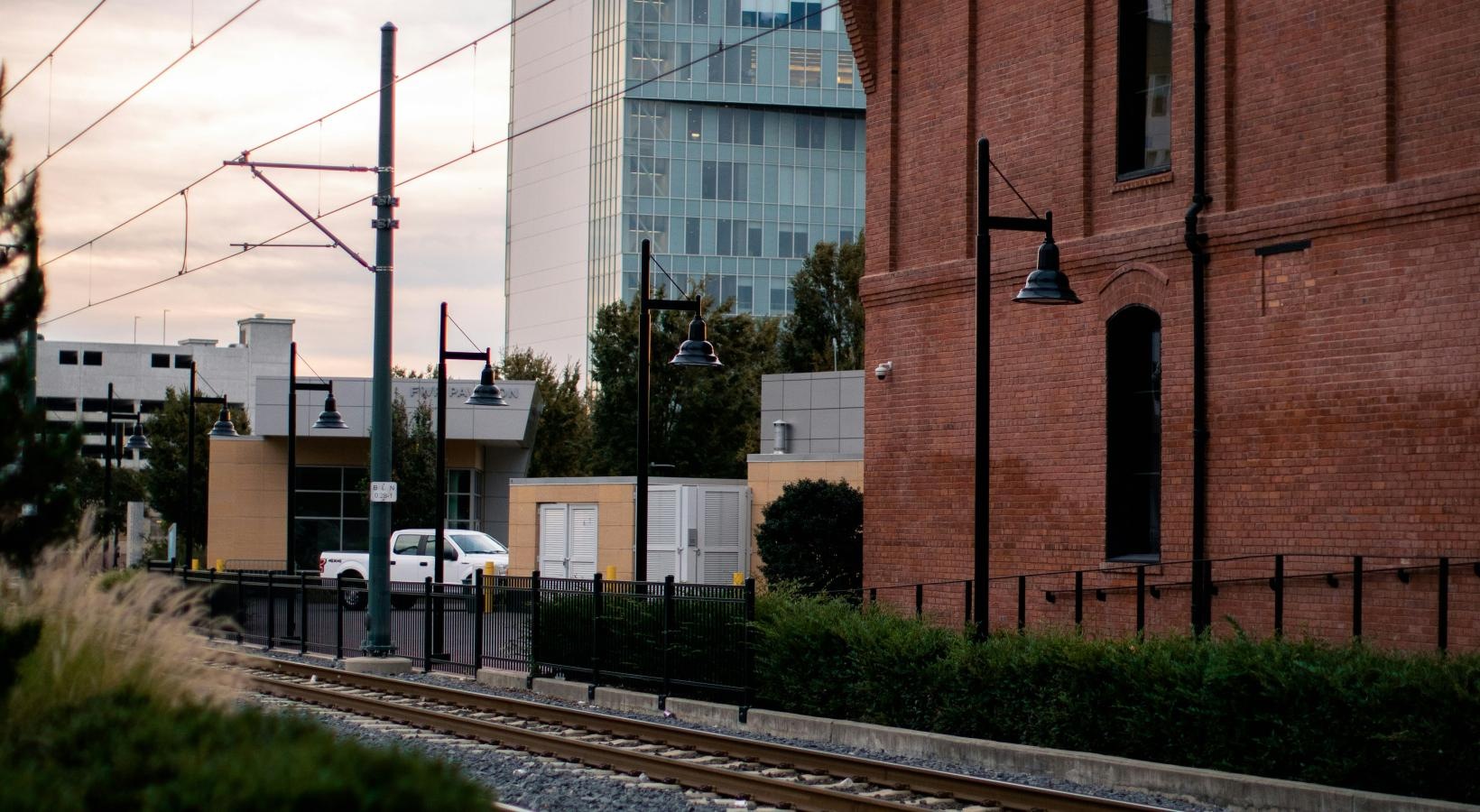 Settle into comfort at Bond on Mint a train track next to a brick building